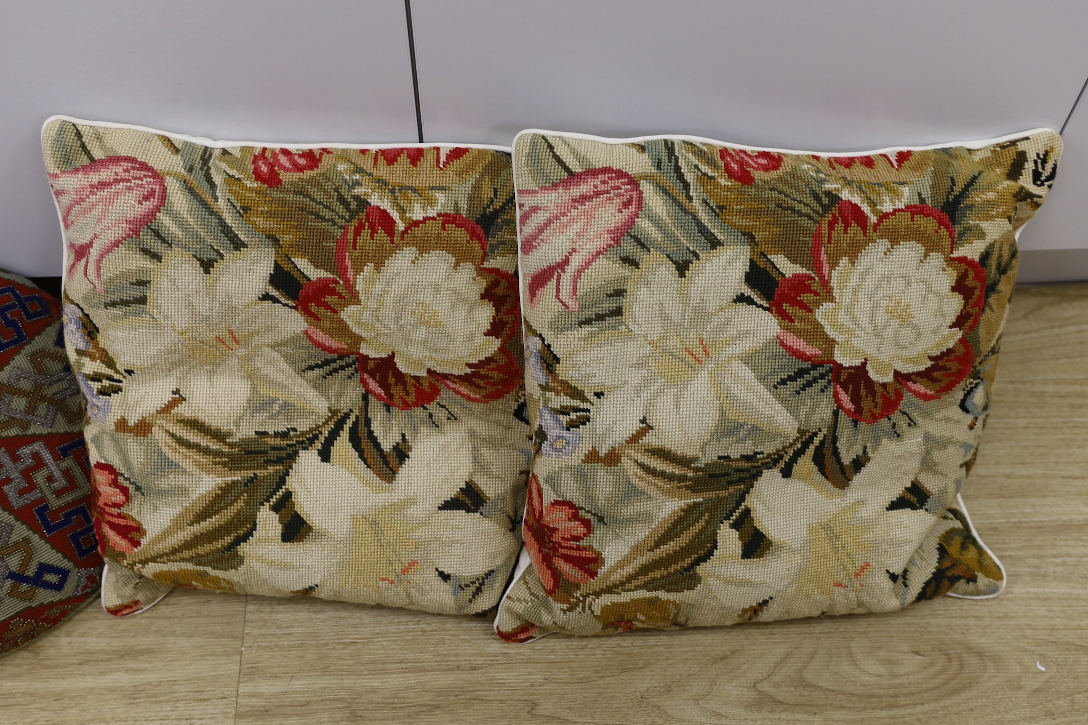 Two pairs of wool work cushions and a 19th century circular Berlin bead work cushion-Berlin bead work cushion 38cms.